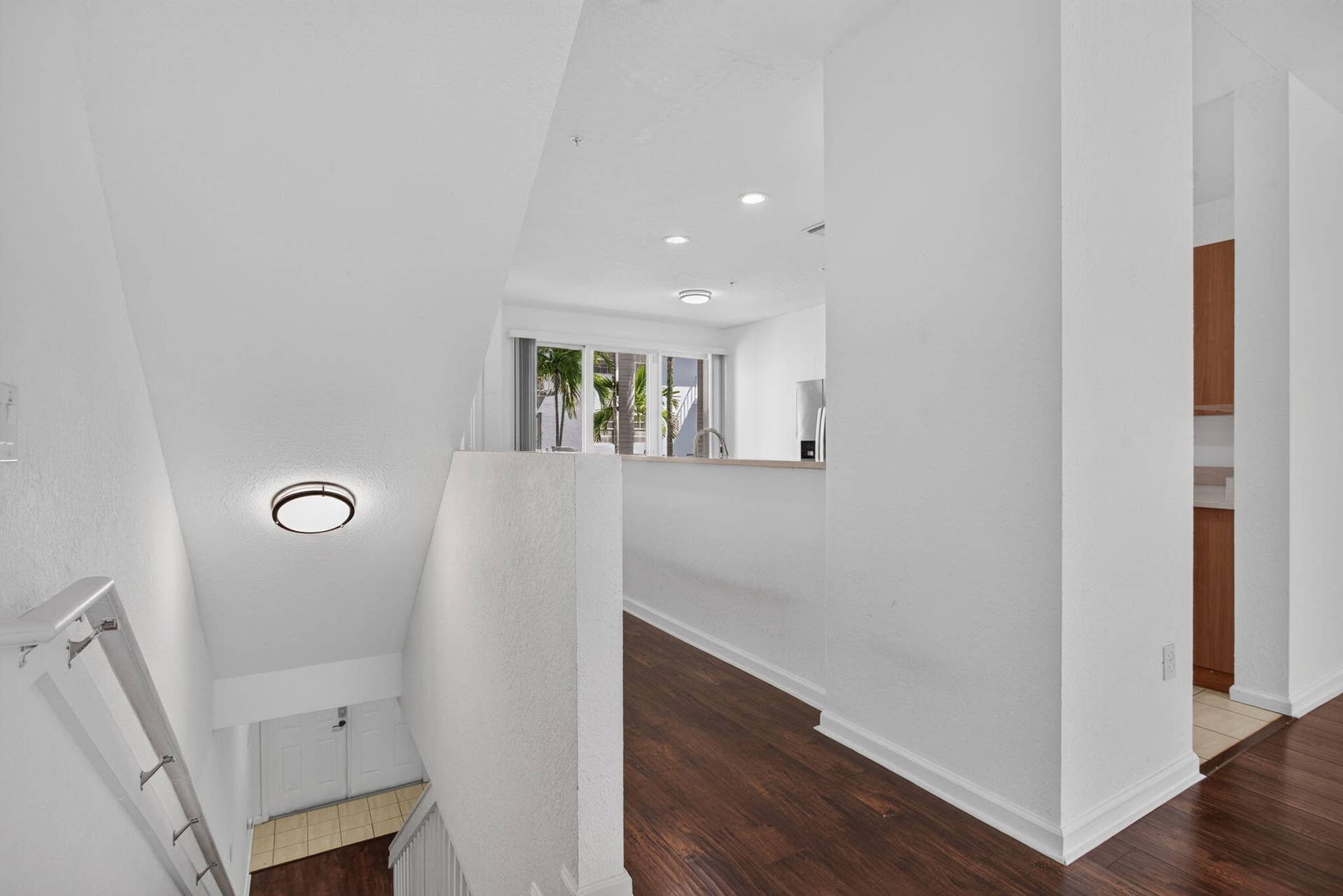 2725 NE 8TH Avenue, #112, Wilton Manors, FL 33334 Wood-finish flooring, recessed lighting, and a contemporary flush-mount ceiling fixture