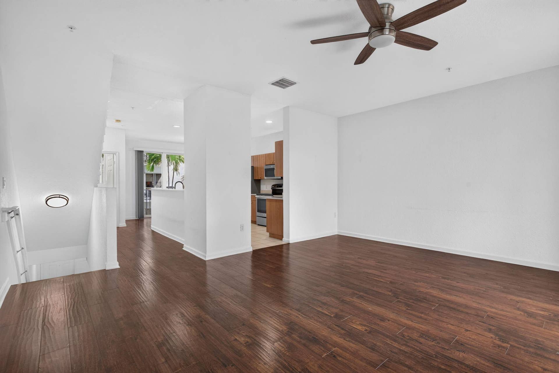 2725 NE 8TH Avenue, #112, Wilton Manors, FL 33334 Wood-finish flooring throughout, high ceilings, and a ceiling fan with integrated lighting