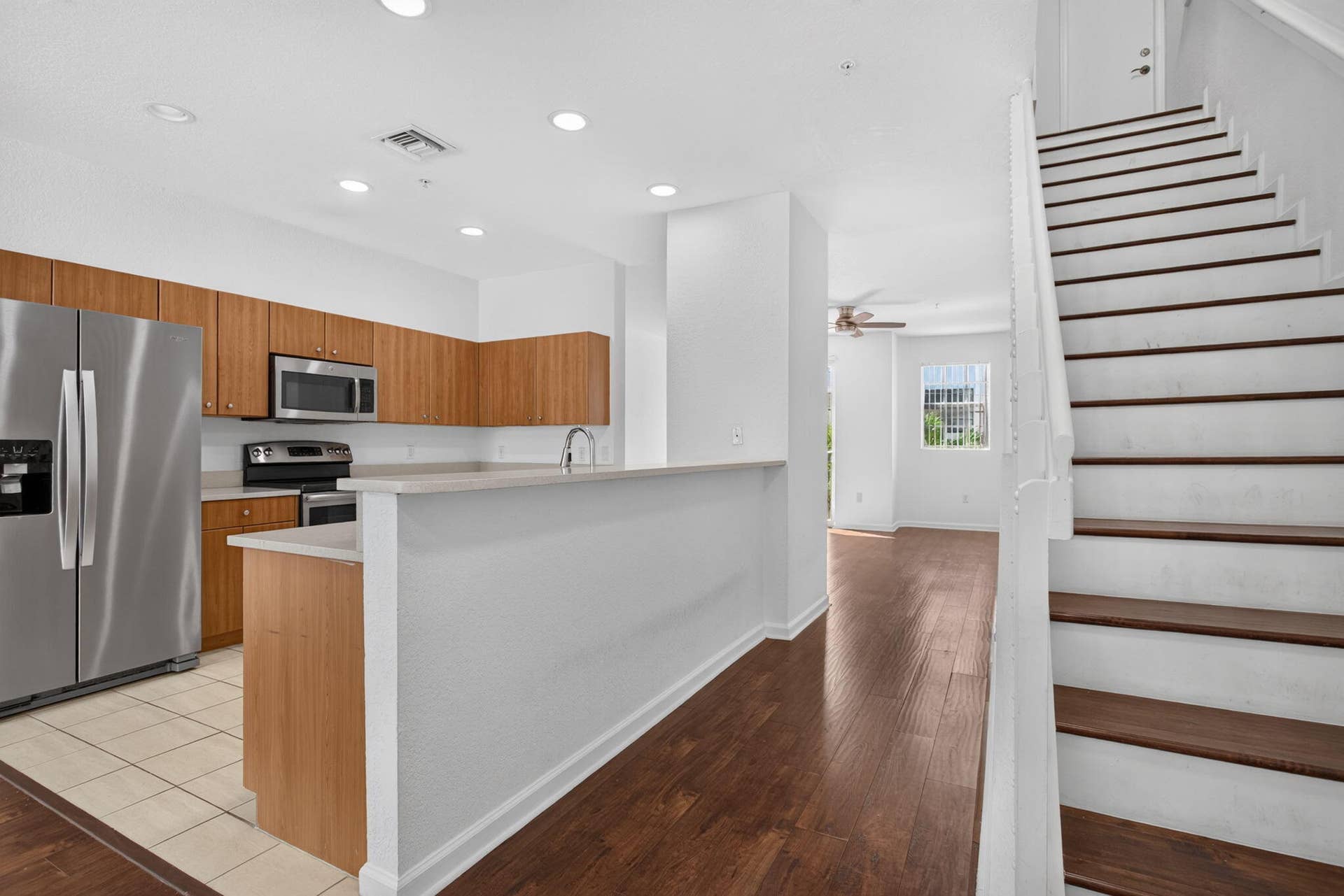 2725 NE 8TH Avenue, #112, Wilton Manors, FL 33334 Kitchen featuring stainless steel appliances, wood-finish cabinetry, and recessed lighting