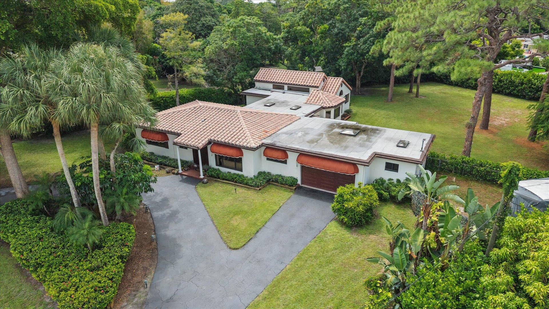 4120 SW 1ST Court, Plantation, FL 33317 Aerial view shows original house horizontal in front and 1991 addition in the back. All windows on the original house are hurricane-rated. All windows on the addition have either clear or aluminum hurricane panels. Laundry room and 4th bathroom are to the right of the garage. Garage and laundry room have hurricane-rated skylights for natural lighting.