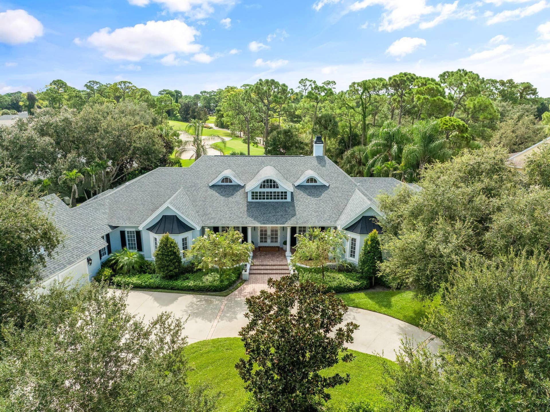 EXPANSIVE CUSTOM ESTATE OVERLOOKING THE 12TH TEE IN PRESTIGIOUS INDIAN RIVER CLUB.