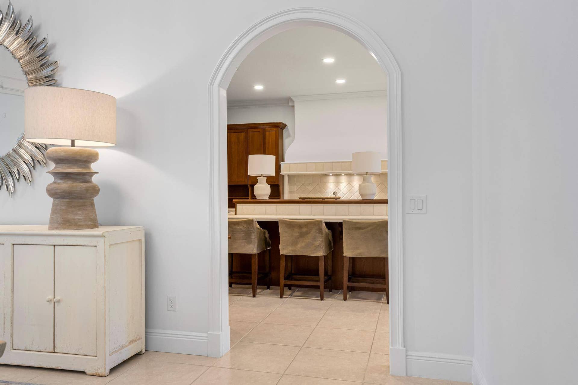 ARCHED ENTRY OFFERS A WELCOMING TRANSITION INTO THE KITCHEN