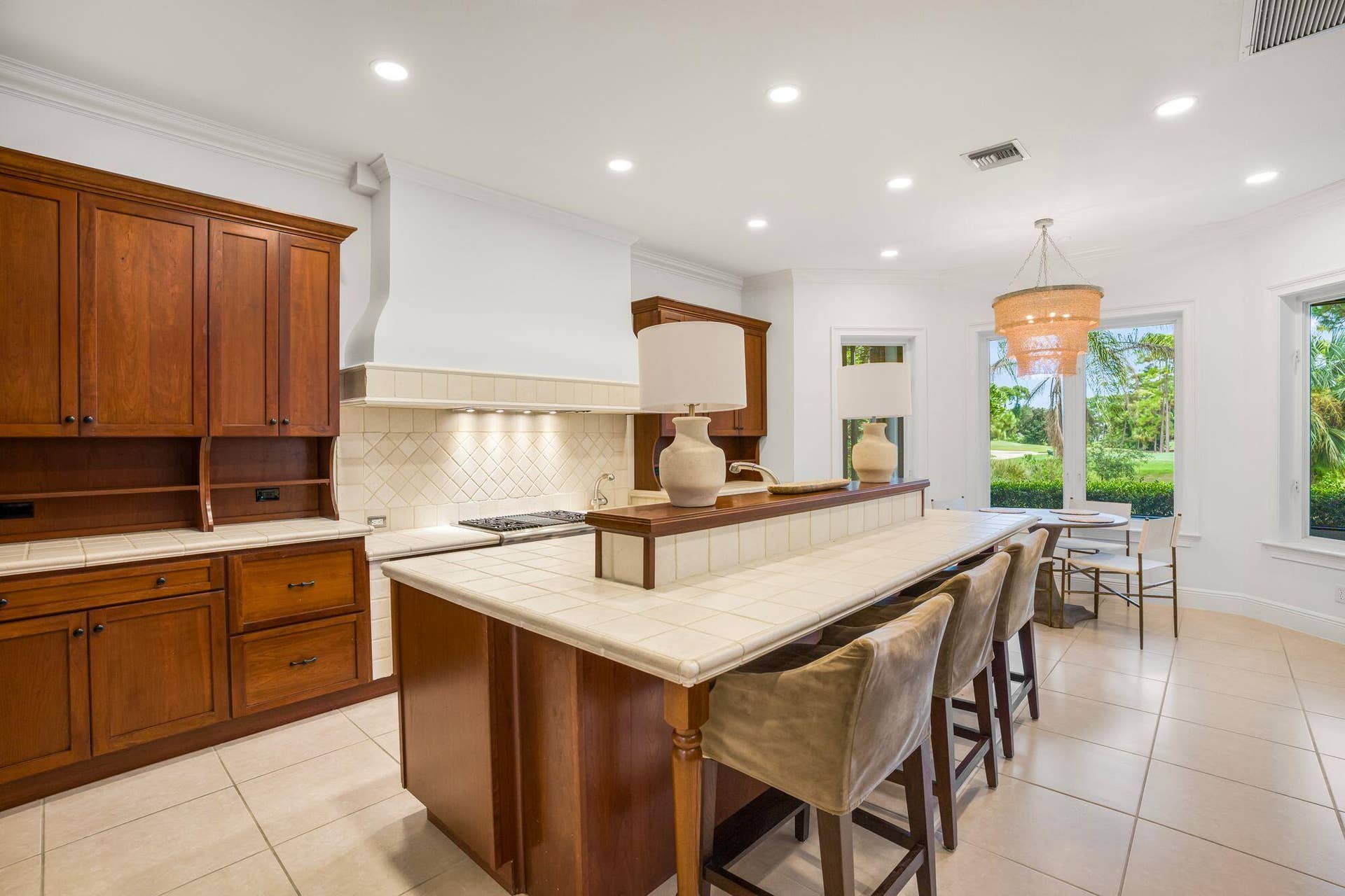 EXPANSIVE OVERSIZED KITCHEN ISLAND WITH GENEROUS SEATING AND ABUNDANT PREP SPACE
