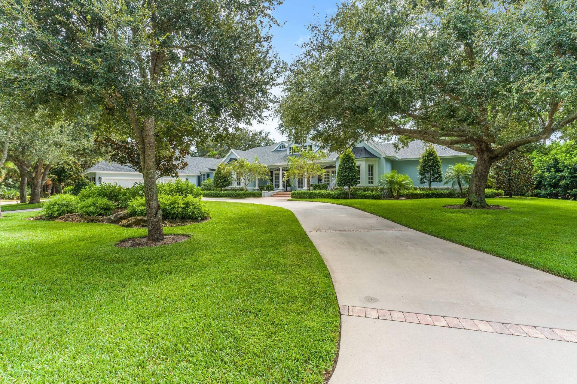 CUSTOM ESTATE HOME WITH SWEEPING CIRCULAR DRIVE AND THREE CAR GARAGE