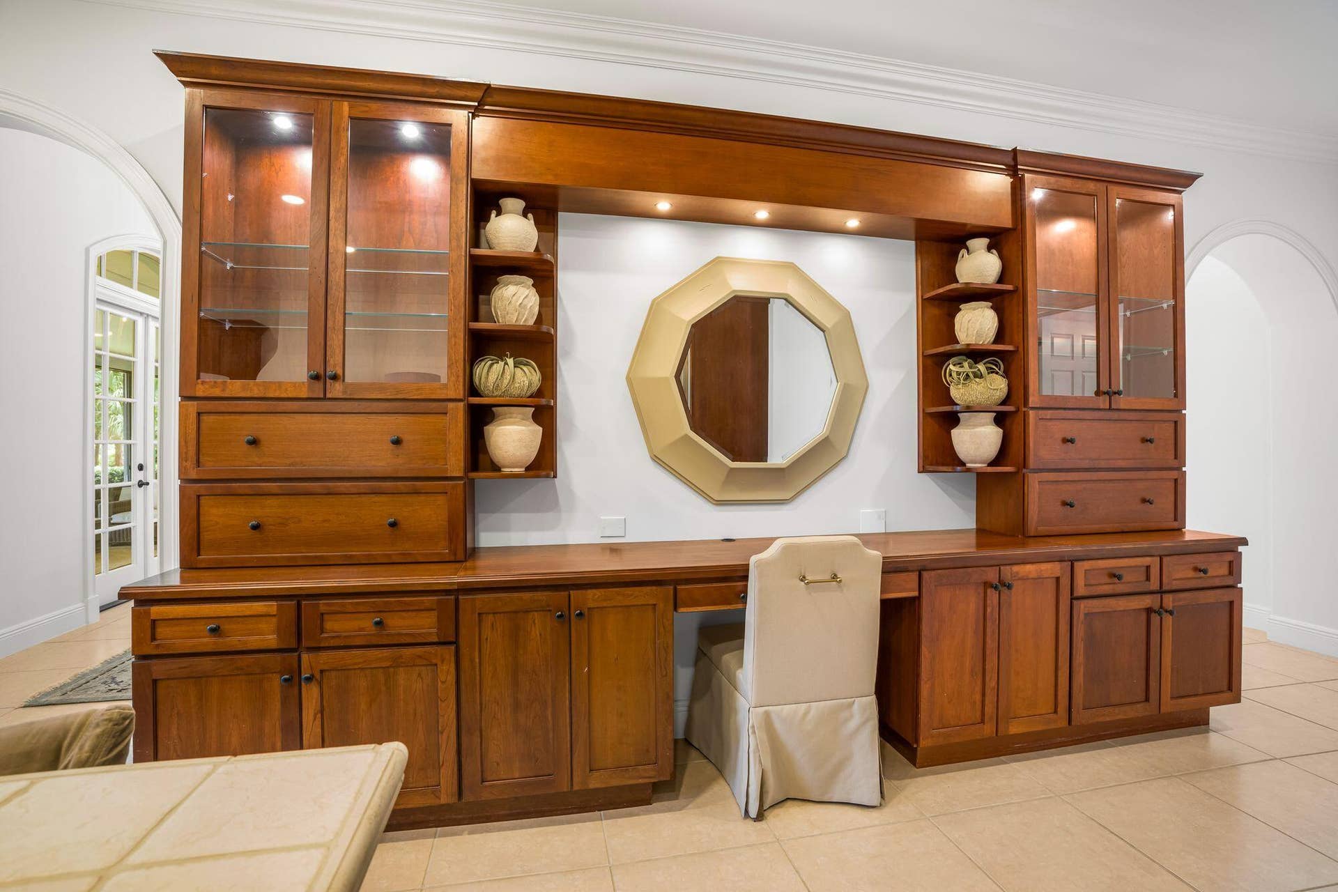 CUSTOM BUILT IN CABINETRY ADDS EXCEPTIONAL STORAGE AND WORKSPACE TO THE KITCHEN