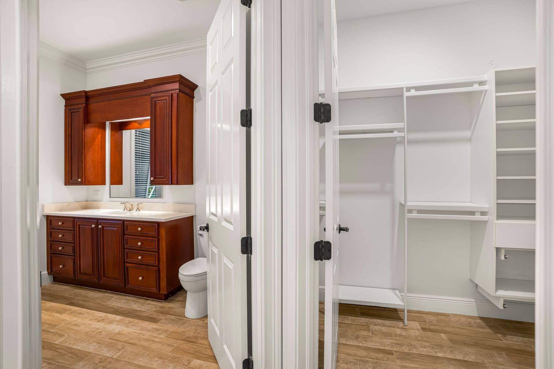 PRIMARY SUITE FEATURING SEPARATE HIS AND HER BATH AREAS WITH GENEROUS WALK IN CLOSET SPACE