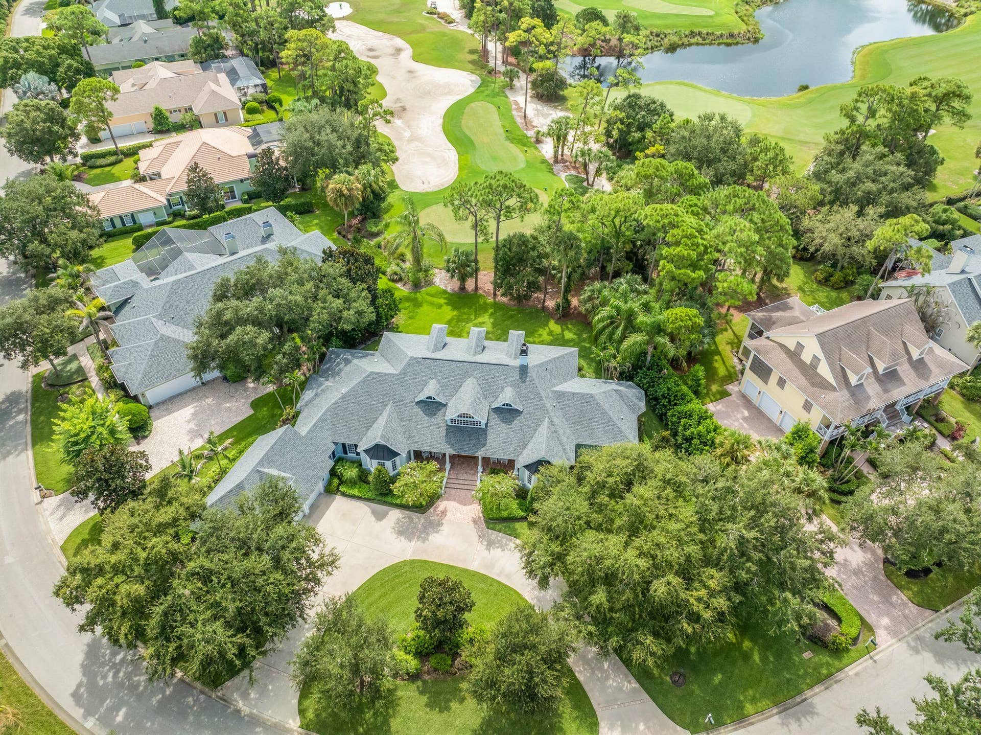 DISTINCTIVE CUSTOM ESTATE SHOWCASING TIMELESS ARCHITECTURE AND GRAND CIRCULAR DRIVEWAY ON .56 ACRES