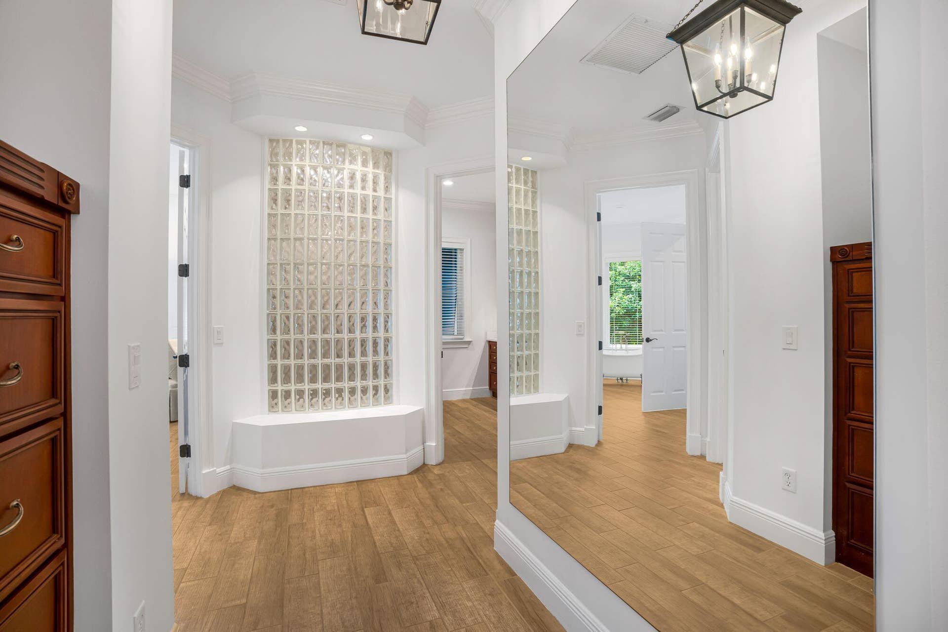BEAUTIFULLY DESIGNED HALLWAY LEADING TO HIS AND HER PRIMARY BATHROOMS