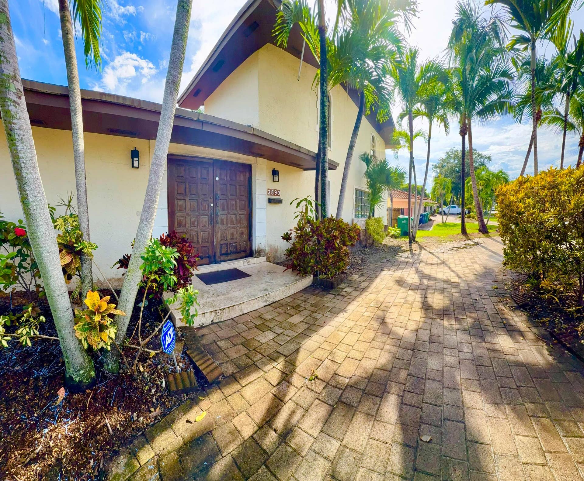 2390 NE 199th Street, Aventura, FL 33180 Architectural entrance featuring a double door, stucco exterior, and accent lighting