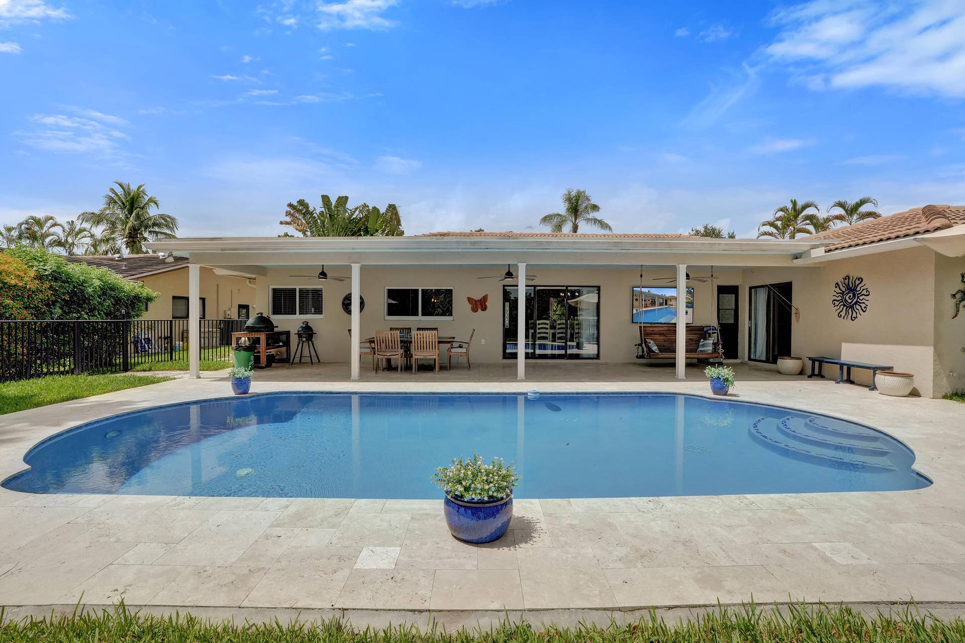 12072 NW 27TH Drive, Coral Springs, FL 33065 Covered patio offering multiple sitting areas with travertine tile