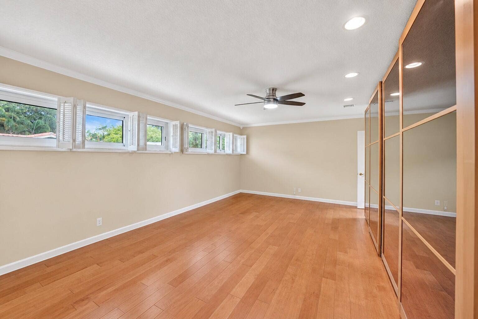 Wood-finish flooring, recessed lighting, and a ceiling fan