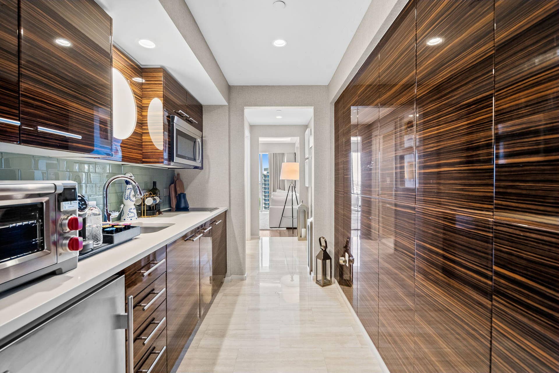 551 N FORT LAUDERDALE BEACH Boulevard, #R1801, Fort Lauderdale, FL 33304 Integrated kitchen cabinetry with wood-grain finish and stainless steel hardware