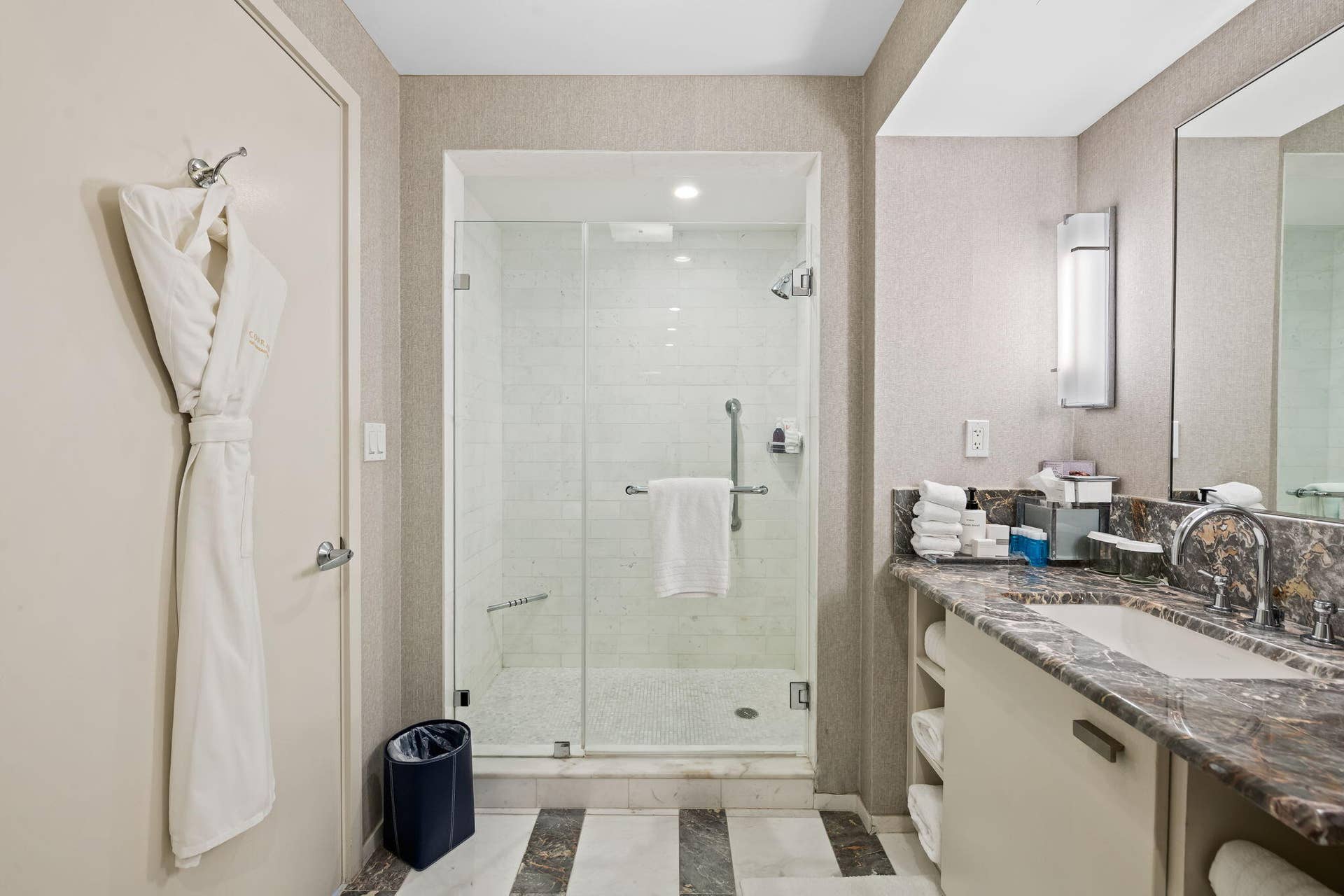 551 N FORT LAUDERDALE BEACH Boulevard, #R1801, Fort Lauderdale, FL 33304 Glass-enclosed shower with subway tile, built-in vanity with stone countertop, under-mount sink, and wall-mounted lighting
