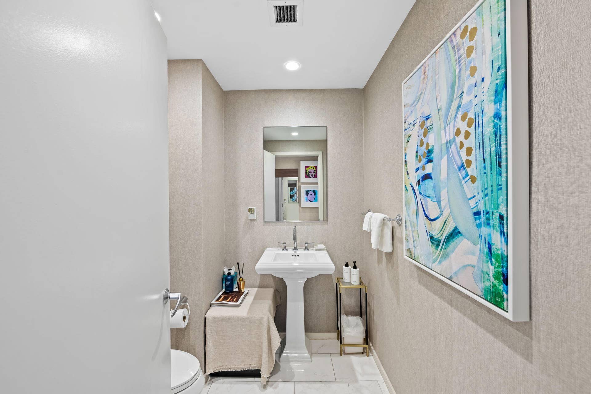 551 N FORT LAUDERDALE BEACH Boulevard, #R1801, Fort Lauderdale, FL 33304 Pedestal sink with polished chrome fixtures, recessed lighting, wall-mounted mirror, and textural wall covering