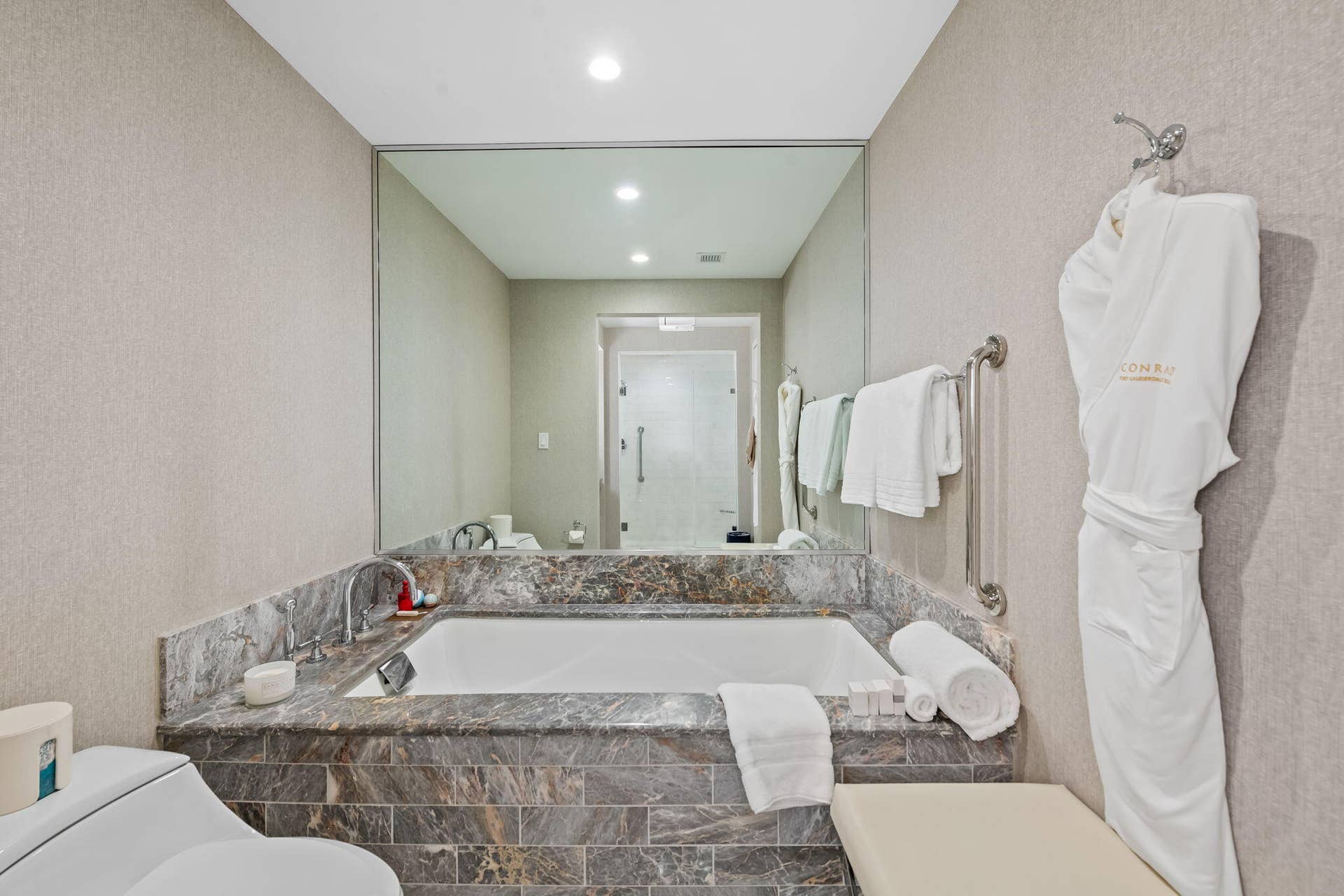 551 N FORT LAUDERDALE BEACH Boulevard, #R1801, Fort Lauderdale, FL 33304 Built-in soaking tub with a stone surround and integrated faucet, complemented by a large wall-mounted mirror