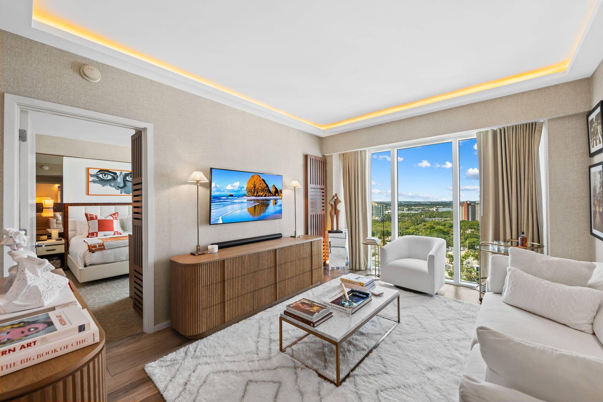 551 N FORT LAUDERDALE BEACH Boulevard, #R1801, Fort Lauderdale, FL 33304 Recessed ceiling lighting, full-height windows, wood-finish flooring, and a built-in media console