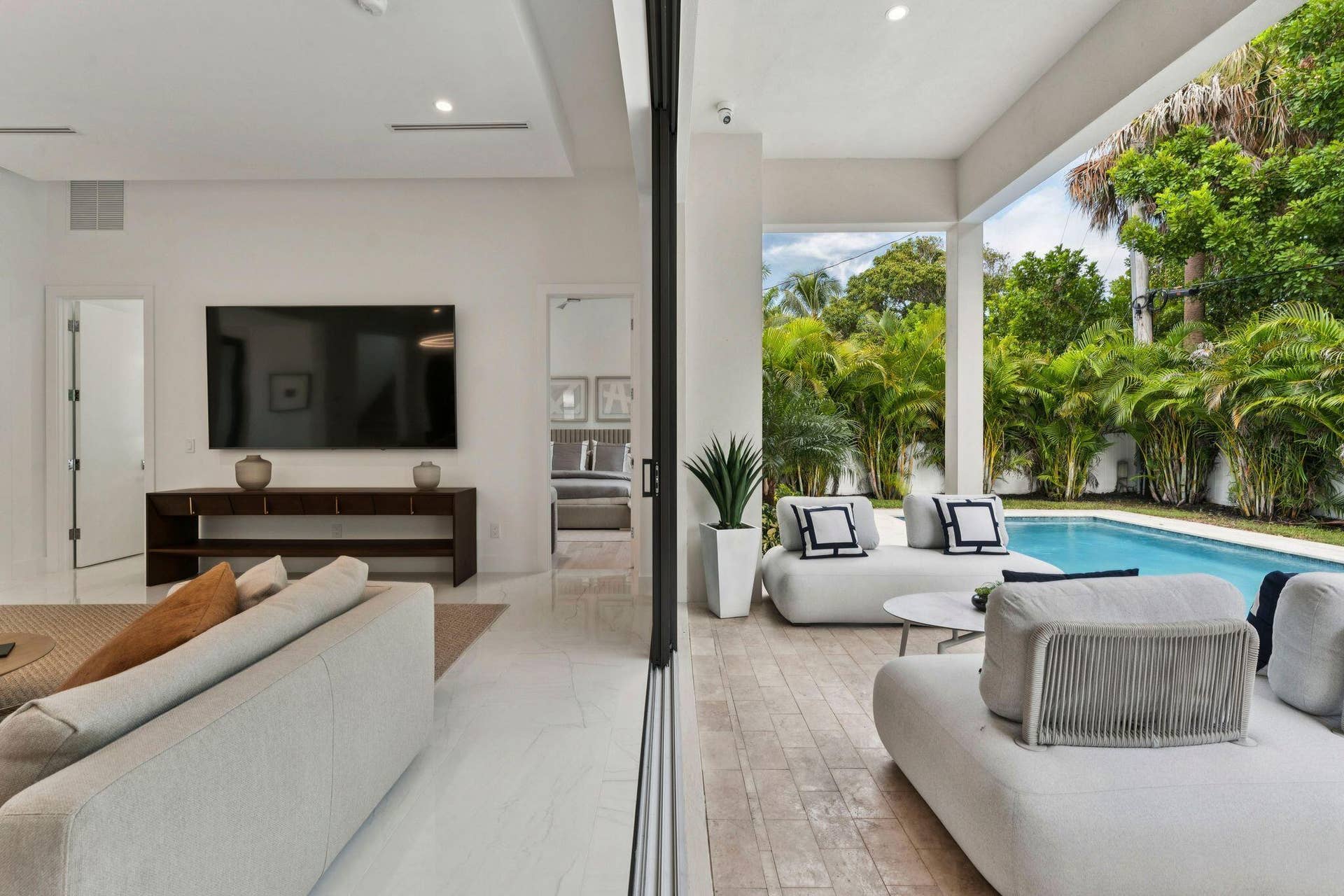 Expansive outdoor living area with covered patio and swimming pool