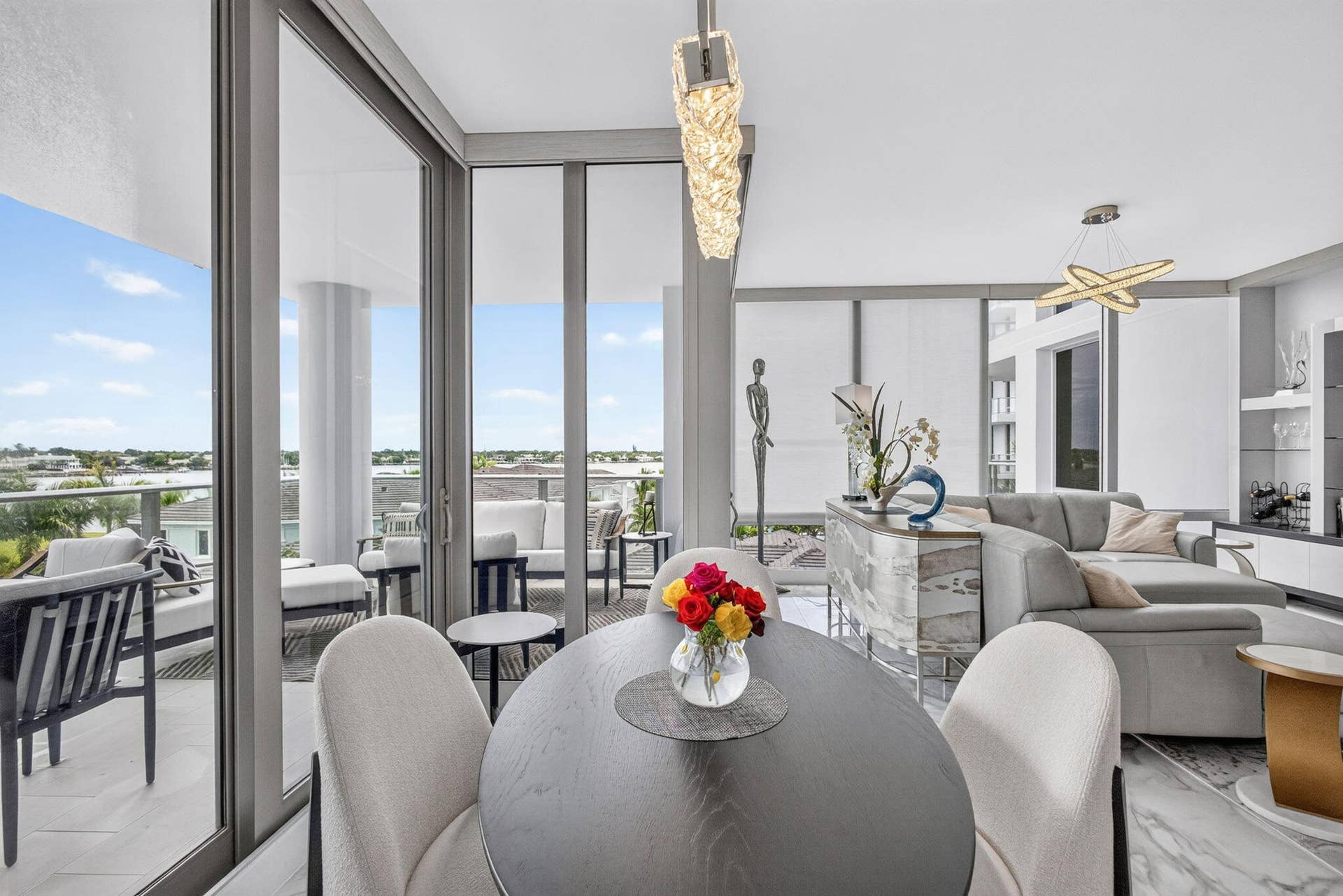 1 Water Club Way, #503, North Palm Beach, FL 33408 Expansive sliding glass doors, contemporary pendant lighting, a built-in bar with a stone-finish counter, and polished tile flooring