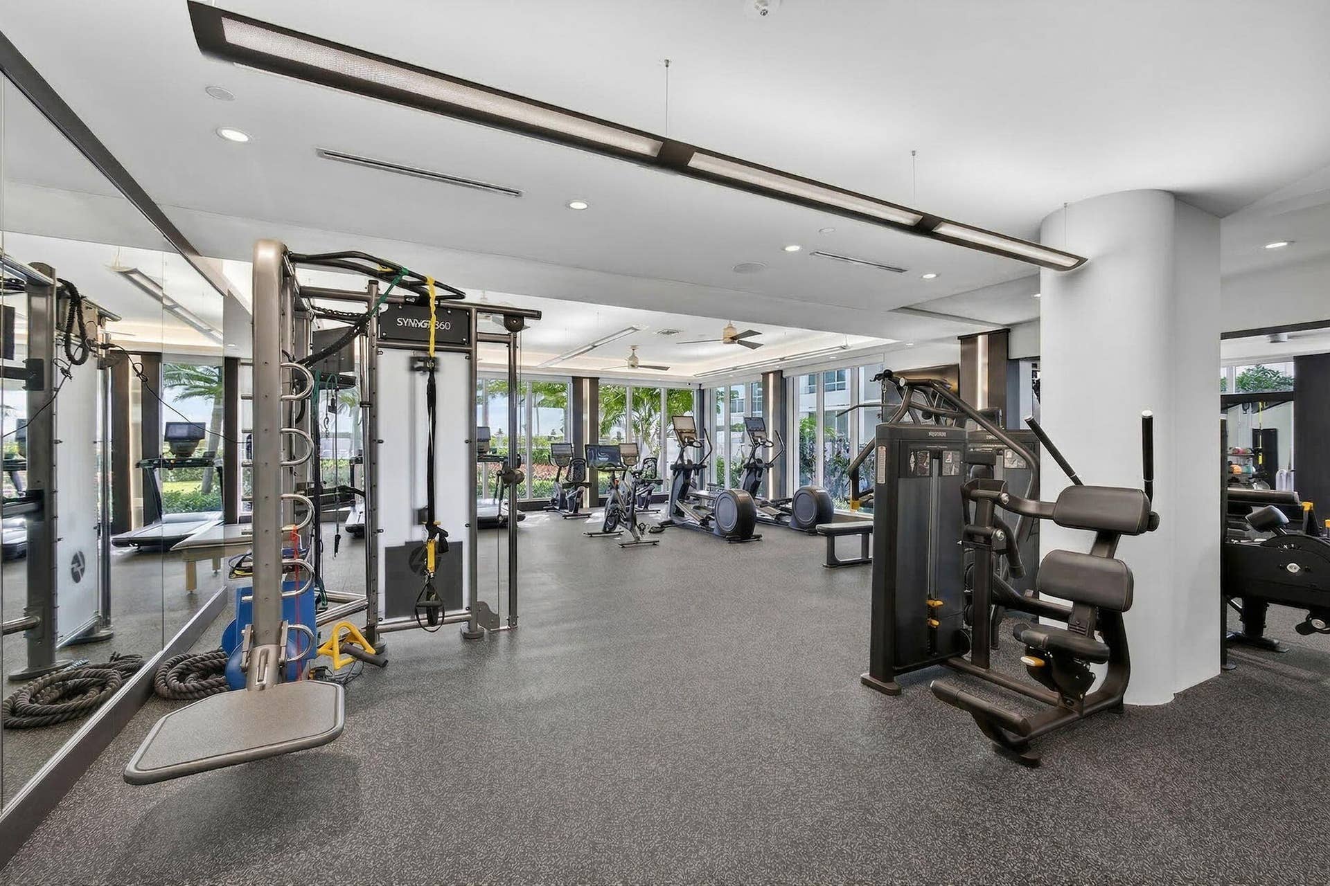 1 Water Club Way, #503, North Palm Beach, FL 33408 Fitness area featuring a rubberized floor, mirrored wall, recessed lighting, and expansive windows
