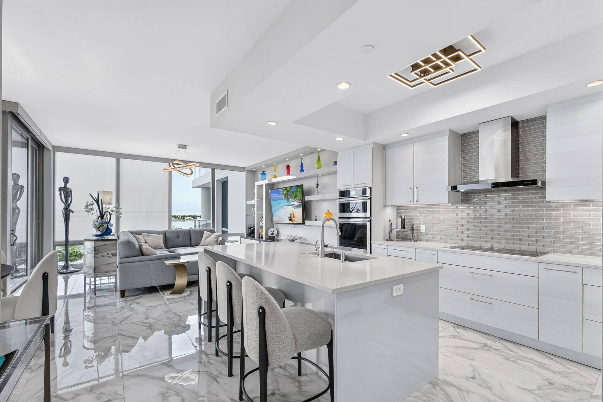 1 Water Club Way, #503, North Palm Beach, FL 33408 Open-concept living space featuring high ceilings, large format tile flooring, and floor-to-ceiling windows