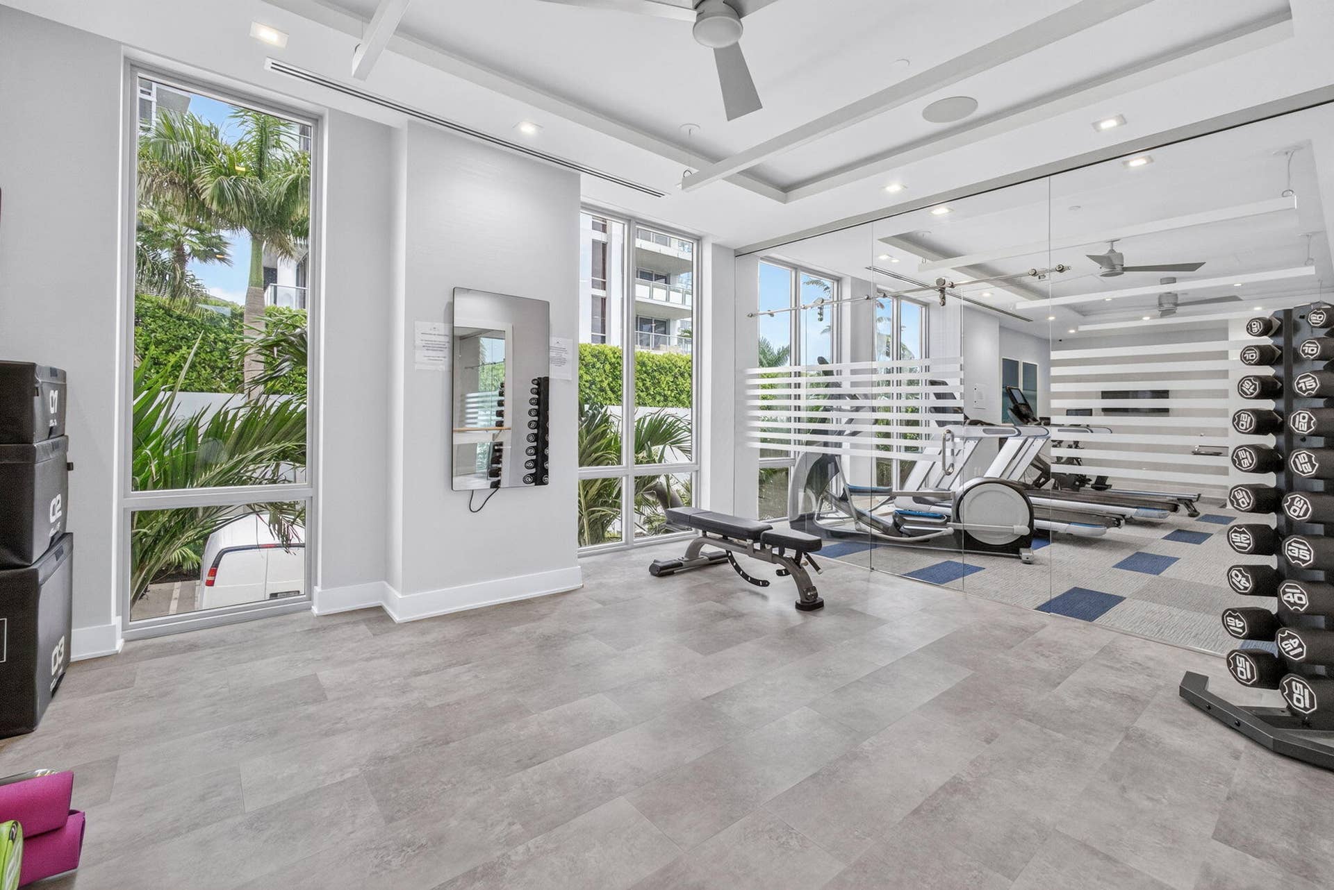 1 Water Club Way, #503, North Palm Beach, FL 33408 Floor-to-ceiling Sunny windows, modern recessed lighting, tray ceiling, full-height mirrored wall, and light-toned flooring
