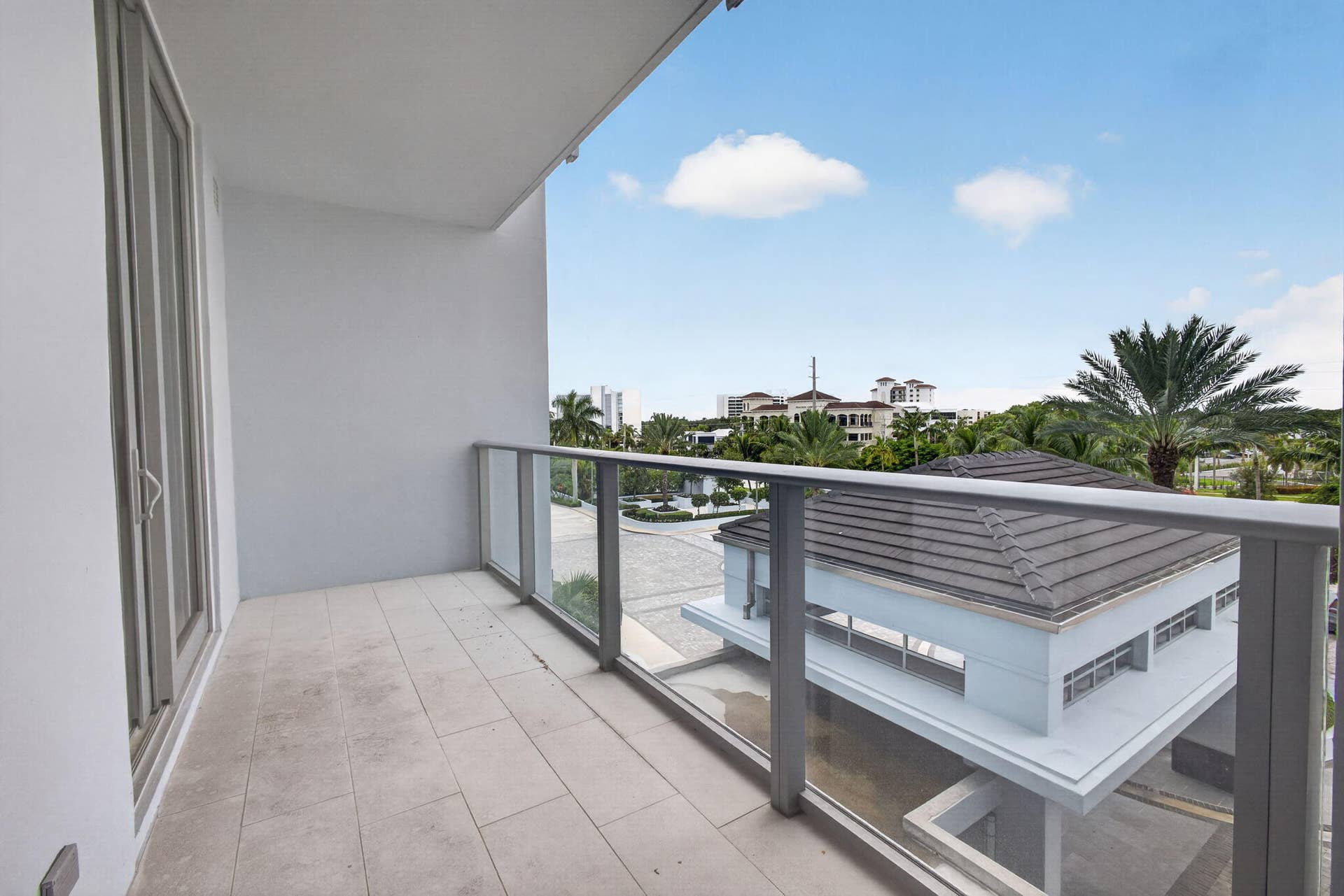 1 Water Club Way, #503, North Palm Beach, FL 33408 Balcony with tile flooring, glass and metal railing, and sliding glass door access