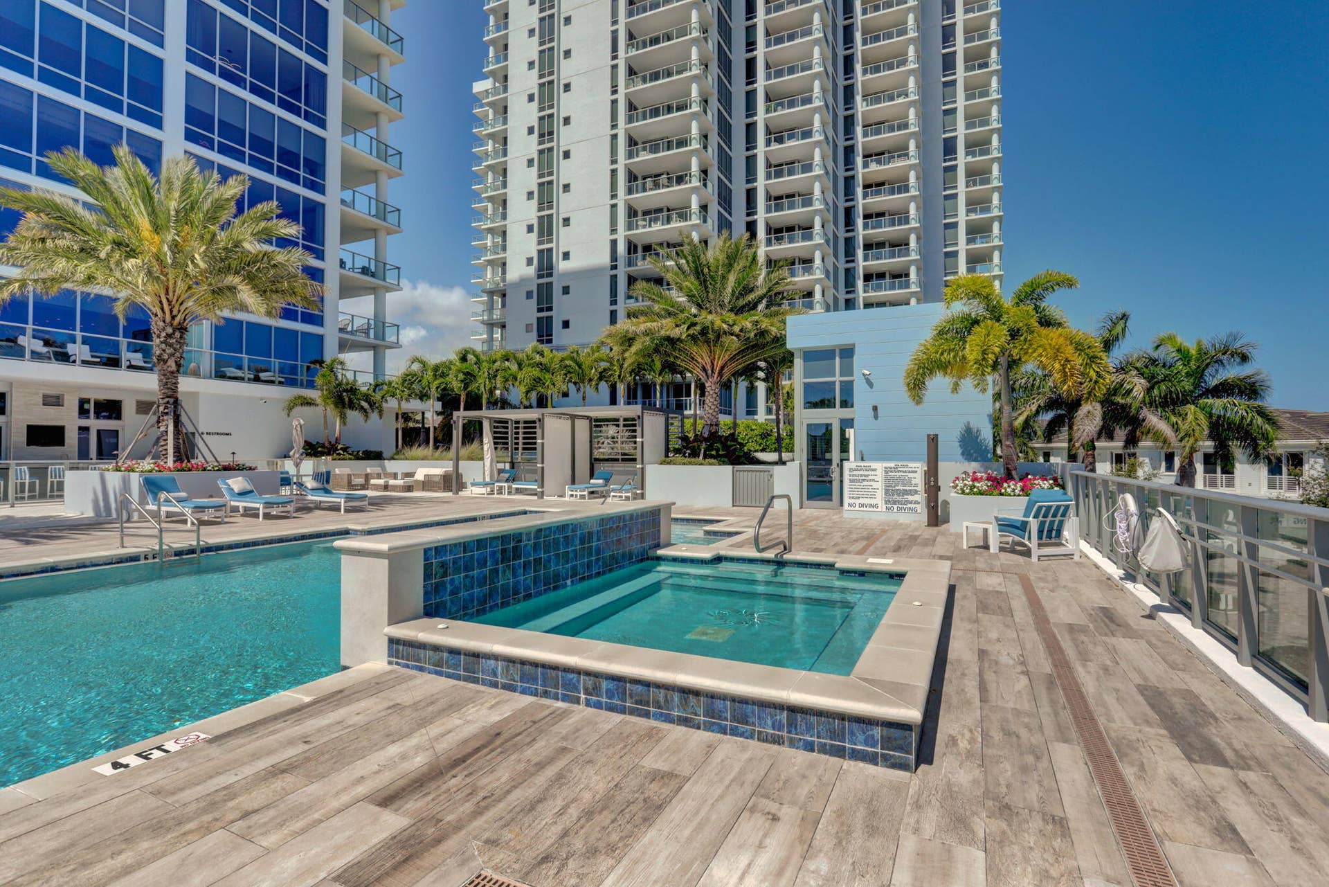 1 Water Club Way, #503, North Palm Beach, FL 33408 Resort-style pool area featuring a rectangular swimming pool, integrated spa, and wood-finish decking