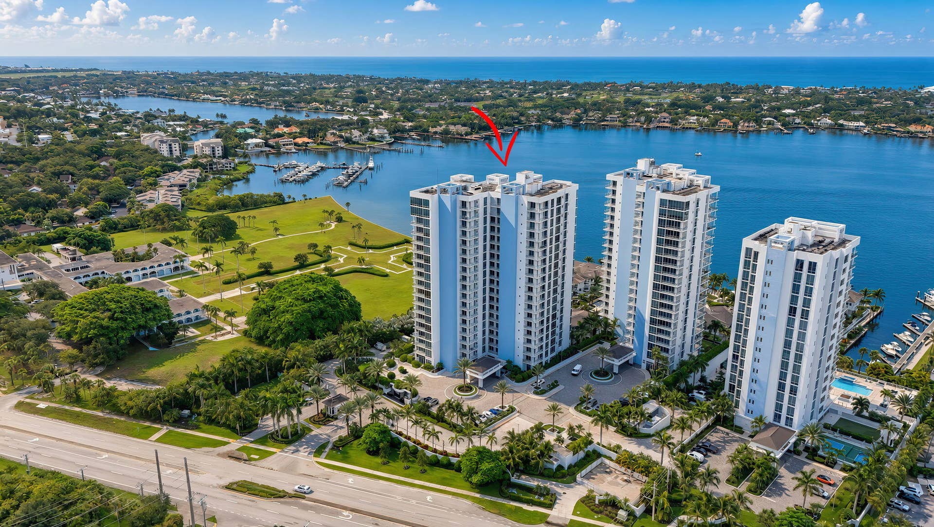 1 Water Club Way, #503, North Palm Beach, FL 33408 Waterfront high-rise building featuring multiple balconies, a circular drive, and lush landscaping
