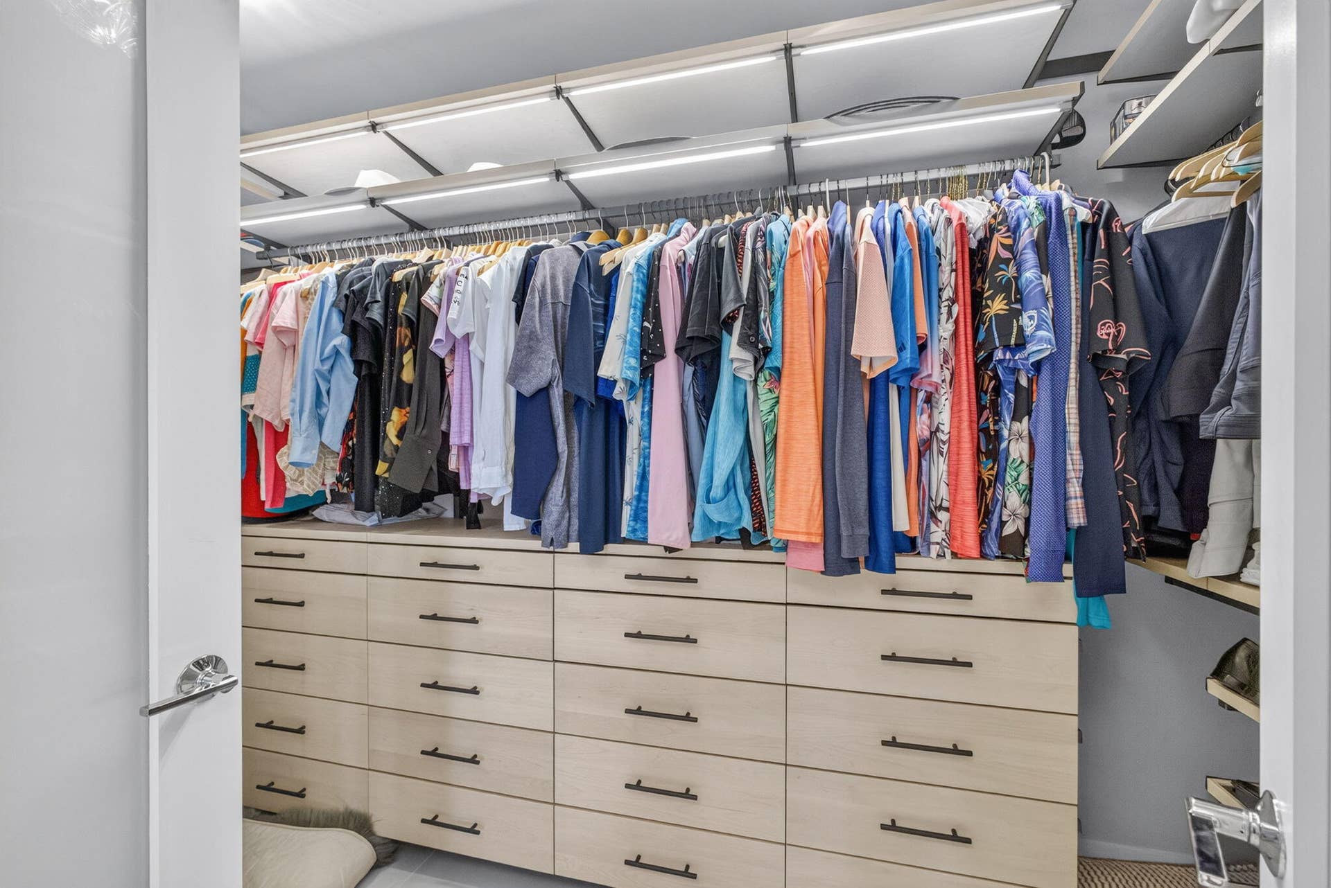 1 Water Club Way, #503, North Palm Beach, FL 33408 Built-in closet system featuring multiple wood-finish drawers, integrated hanging rods, and recessed overhead lighting