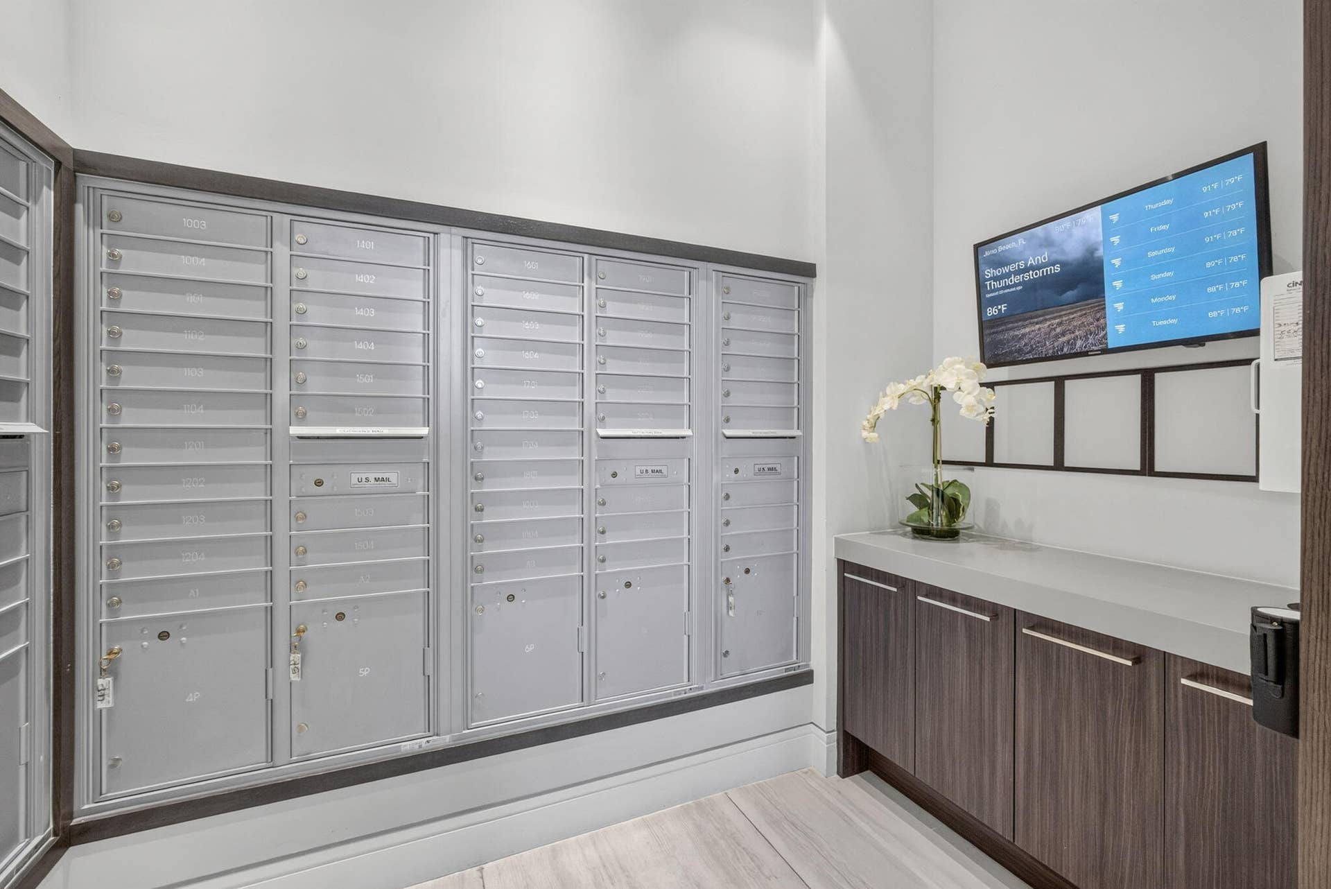 1 Water Club Way, #503, North Palm Beach, FL 33408 Catch up on the days news while picking up your mail just off thel lobby on your way to the elevaor. Wall-mounted mailboxes with a wood-finish base, integrated cabinetry, and a light-colored countertop