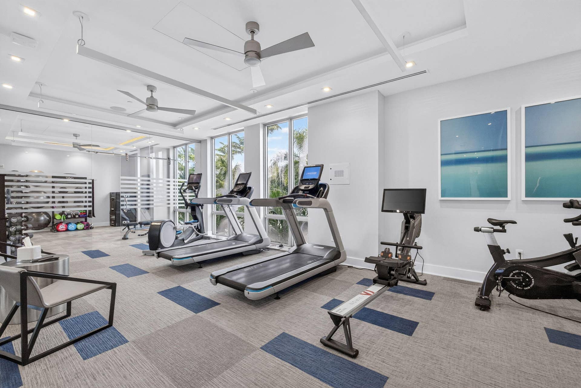 1 Water Club Way, #503, North Palm Beach, FL 33408 Fitness center featuring large Sunny windows, patterned carpet, recessed lighting, and ceiling fans