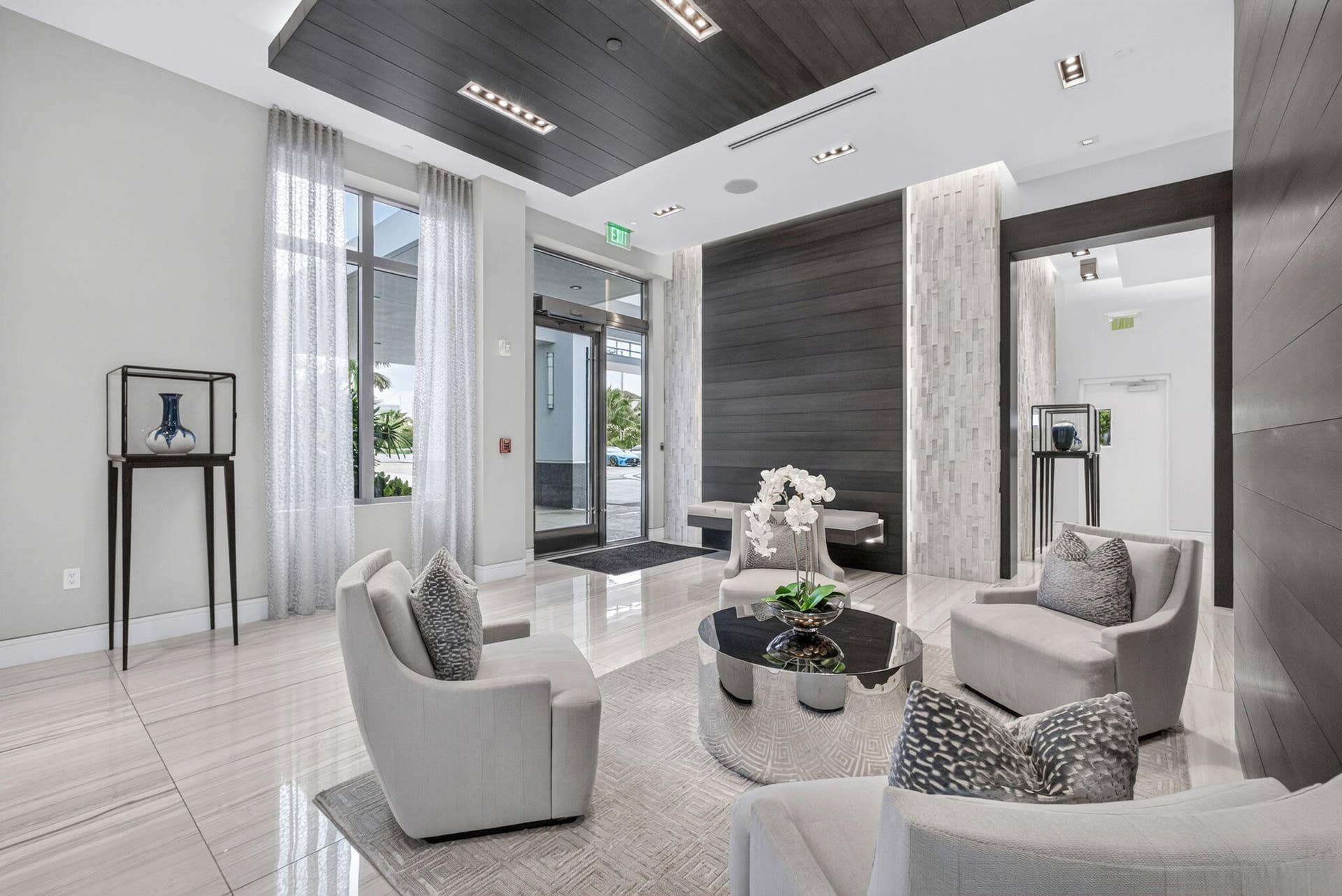 1 Water Club Way, #503, North Palm Beach, FL 33408 This stunning lobby featuring large format tile flooring, a wood-paneled ceiling with recessed lighting, full-height windows, a textured accent wall, and wood-paneled walls will be the envy of both friends & family.