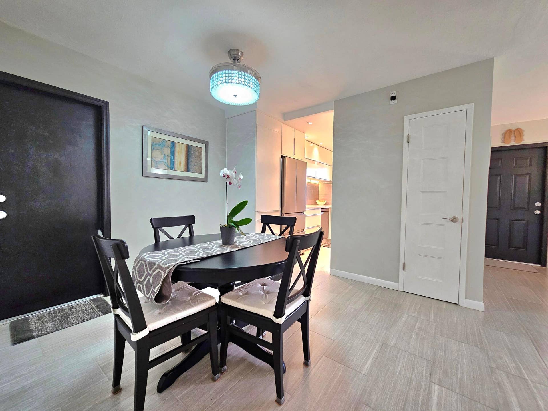 DINING ROOM SHOWING BACK DOOR TO PRIVATE PATIO AND ENTRANCE TO KITCHEN