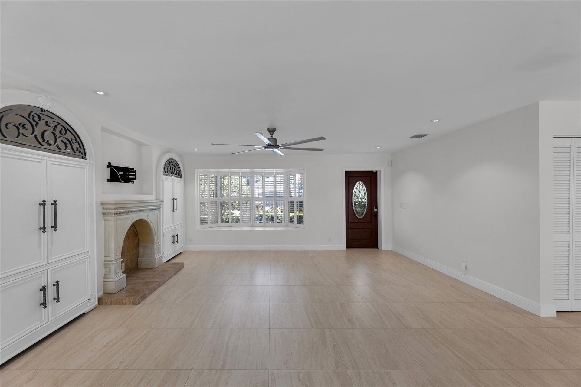 2401 NE 47TH Street, Lighthouse Point, Lighthouse Point, FL 33064 Living room offers a bay window, fireplace and great storage on each side of fireplace