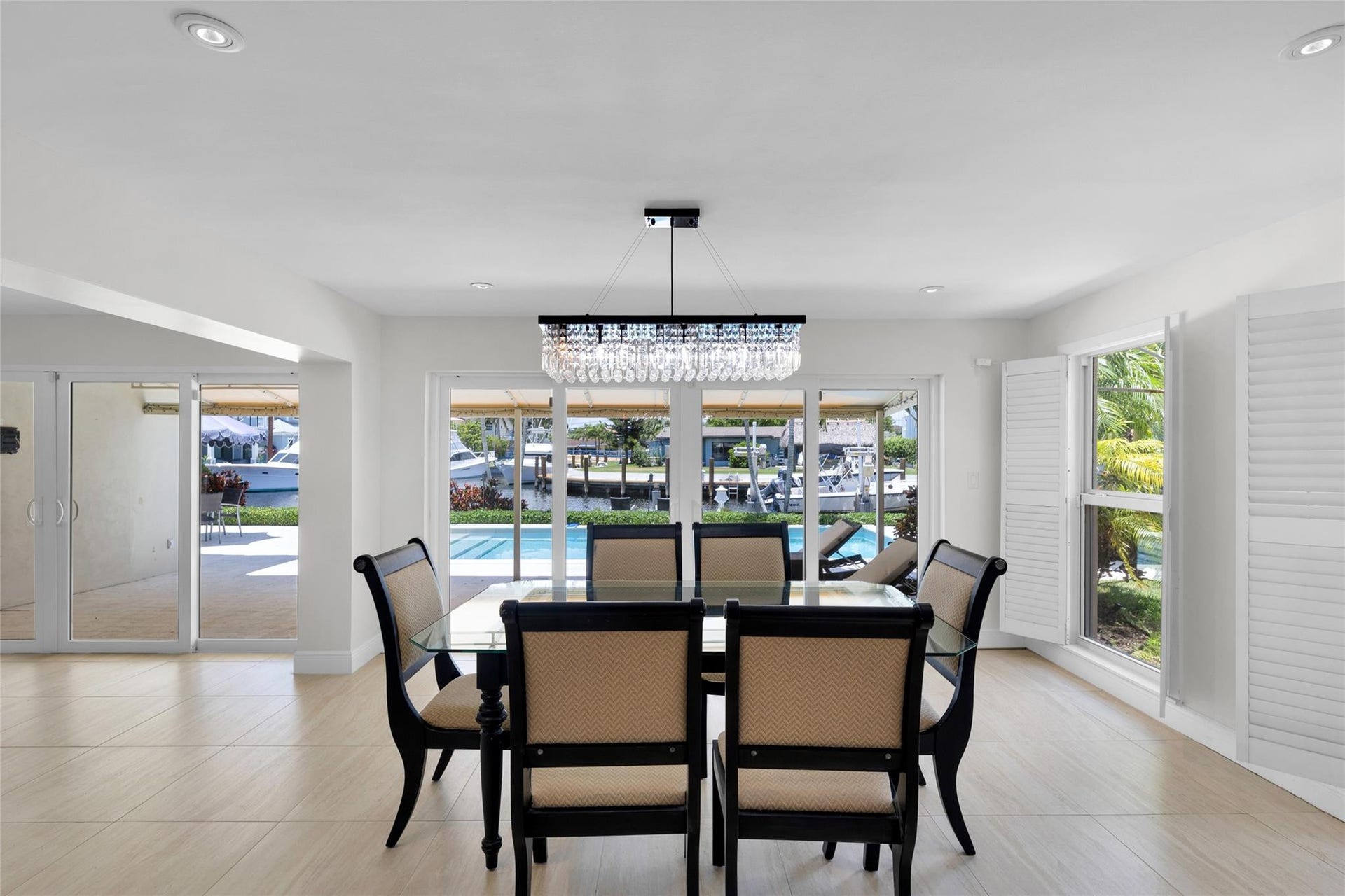 2401 NE 47TH Street, Lighthouse Point, Lighthouse Point, FL 33064 Dining room offers sliders & pool and water views