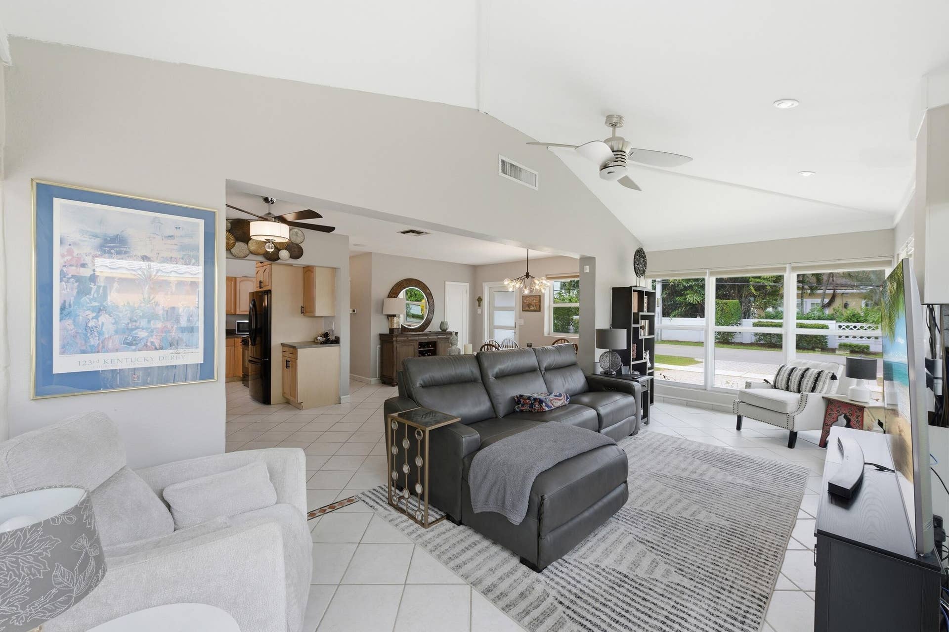 1421 SW 20 Street, Fort Lauderdale, FL 33315 Vaulted ceilings with recessed lighting, large pane windows, tile flooring with decorative inlay, and a ceiling fan