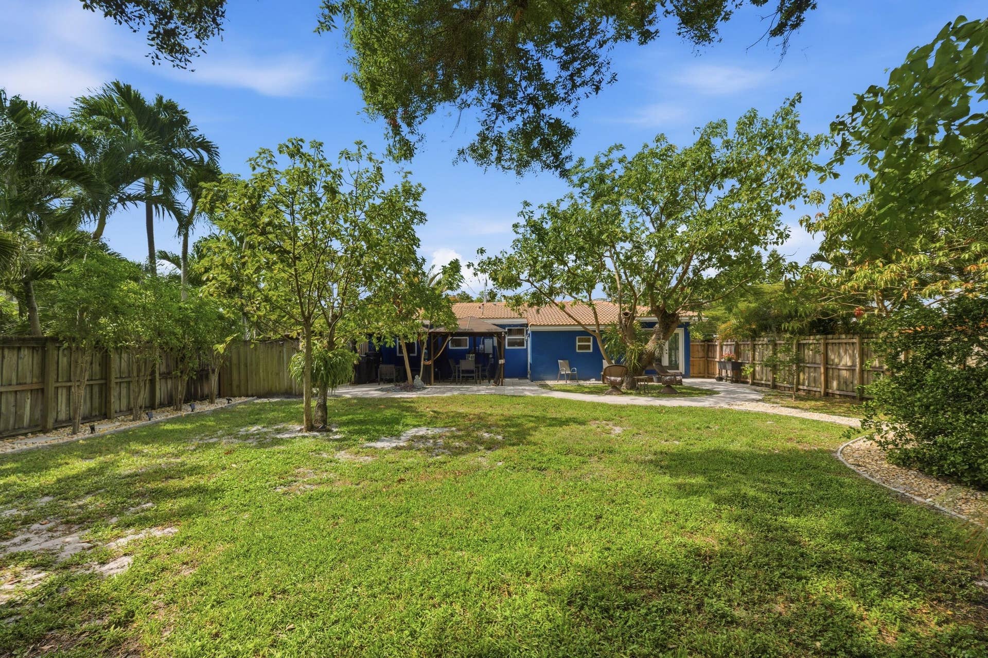 1421 SW 20 Street, Fort Lauderdale, FL 33315 Expansive grass lawn with mature trees and a fenced perimeter