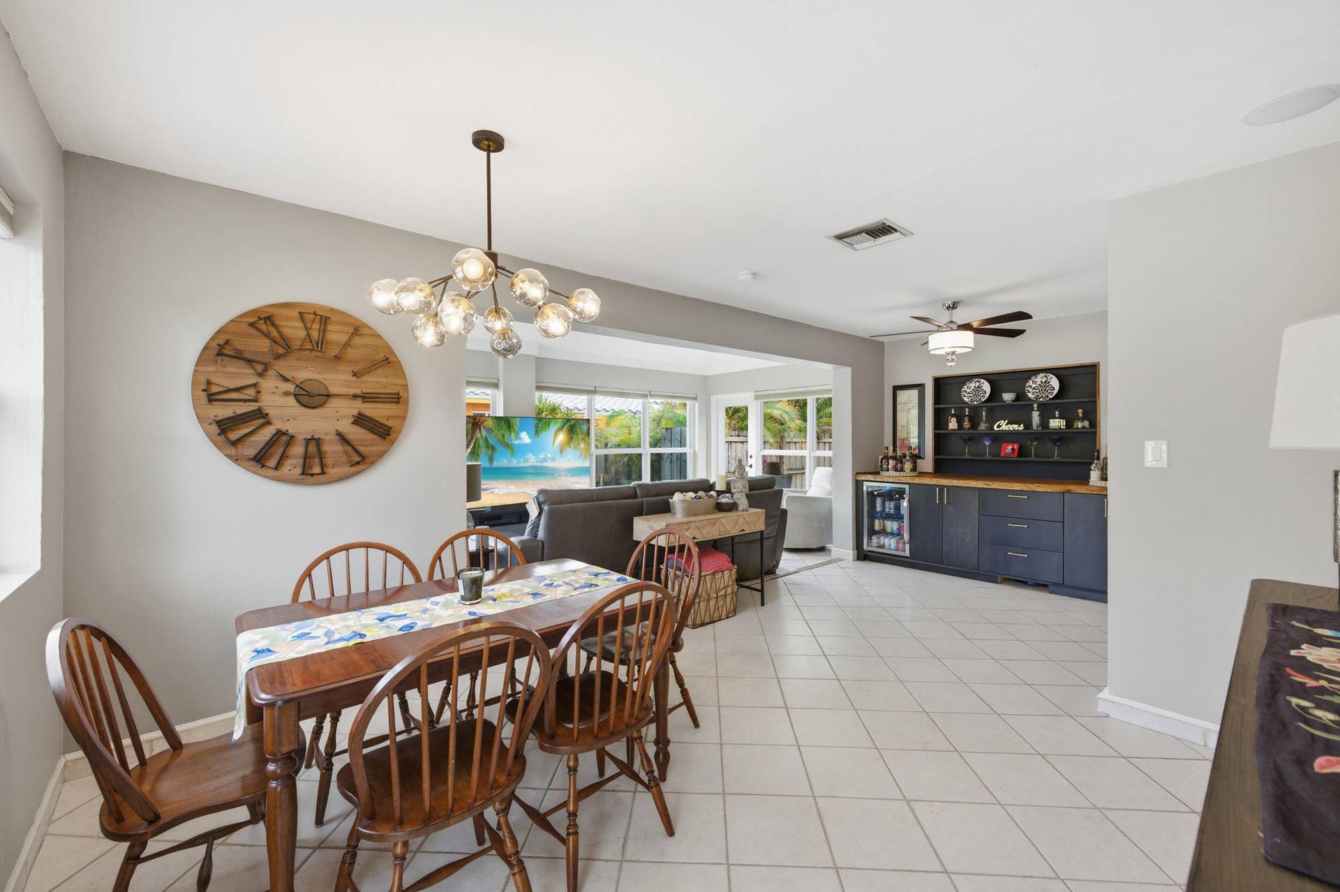 1421 SW 20 Street, Fort Lauderdale, FL 33315 Tiled flooring, modern chandelier, built-in bar cabinetry with wood-finish countertop, and recessed lighting