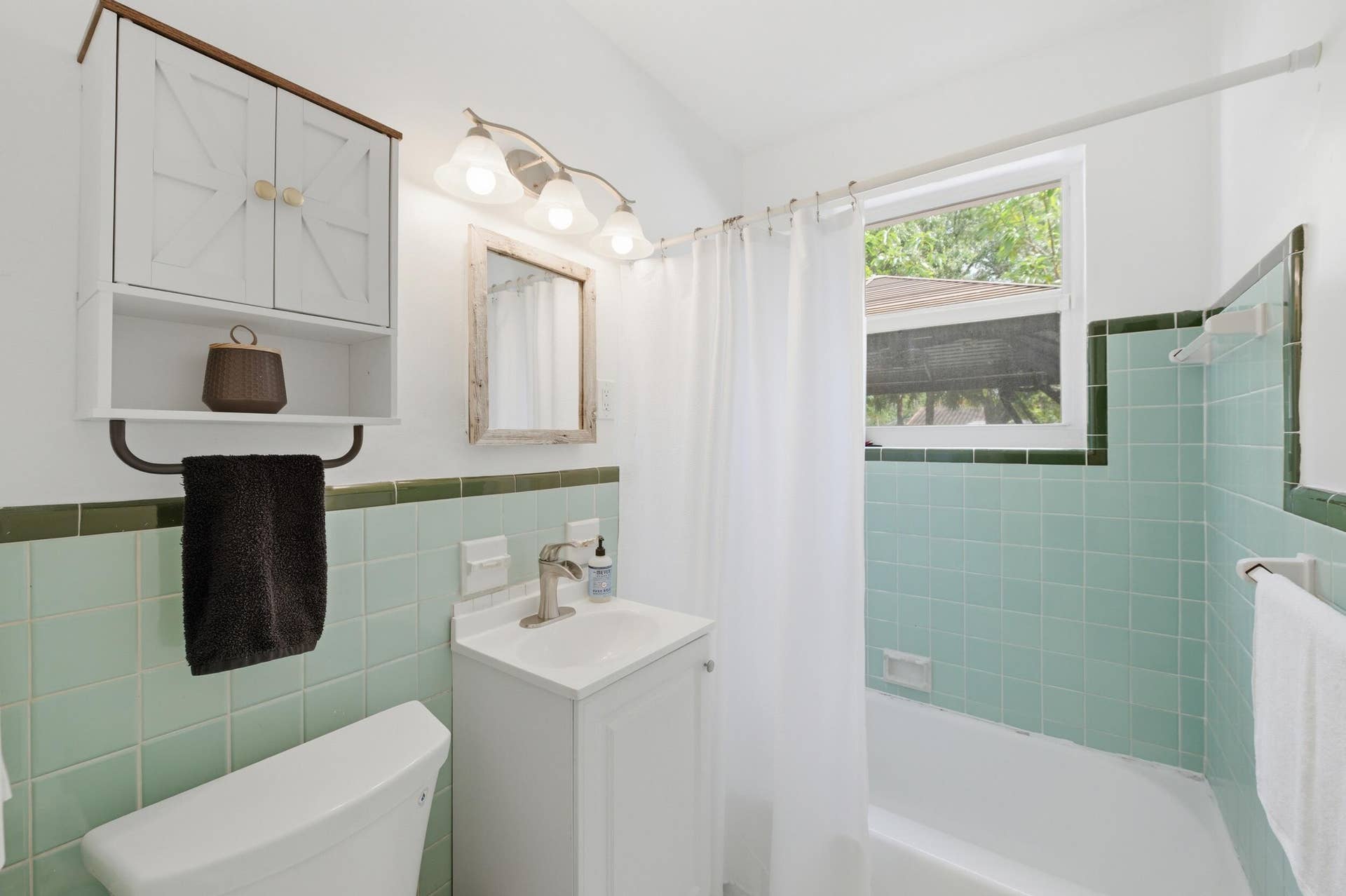 1421 SW 20 Street, Fort Lauderdale, FL 33315 Recessed bathtub with a shower curtain, a single-pane window, and light green tiled walls
