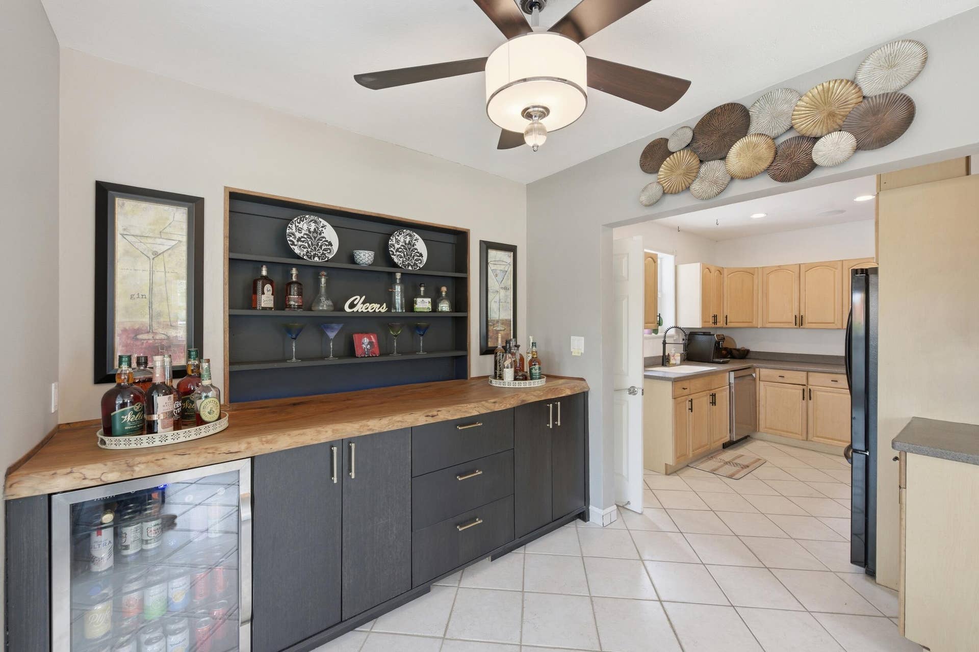 1421 SW 20 Street, Fort Lauderdale, FL 33315 Built-in cabinetry with wood-finish countertop, beverage refrigerator, open shelving, ceiling fan, and tile flooring