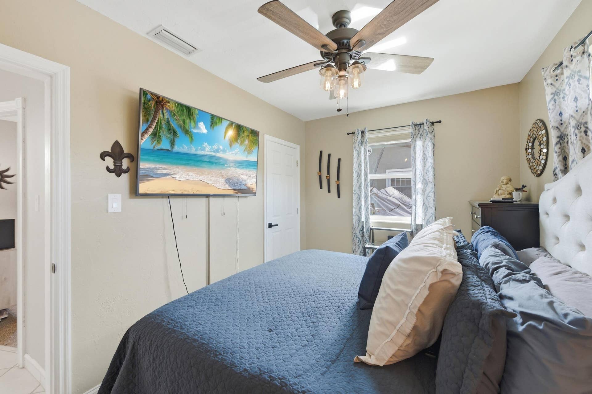 1421 SW 20 Street, Fort Lauderdale, FL 33315 Ceiling fan with integrated lighting, wall-mounted television, and a window with natural light
