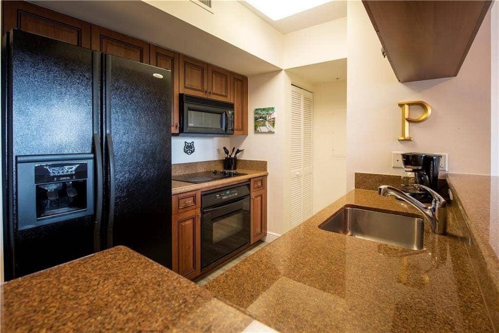 347 N New River Drive E, #1005, Fort Lauderdale, FL 33301 Galley kitchen with granite counter tops - Portelain floors throughout the living areas