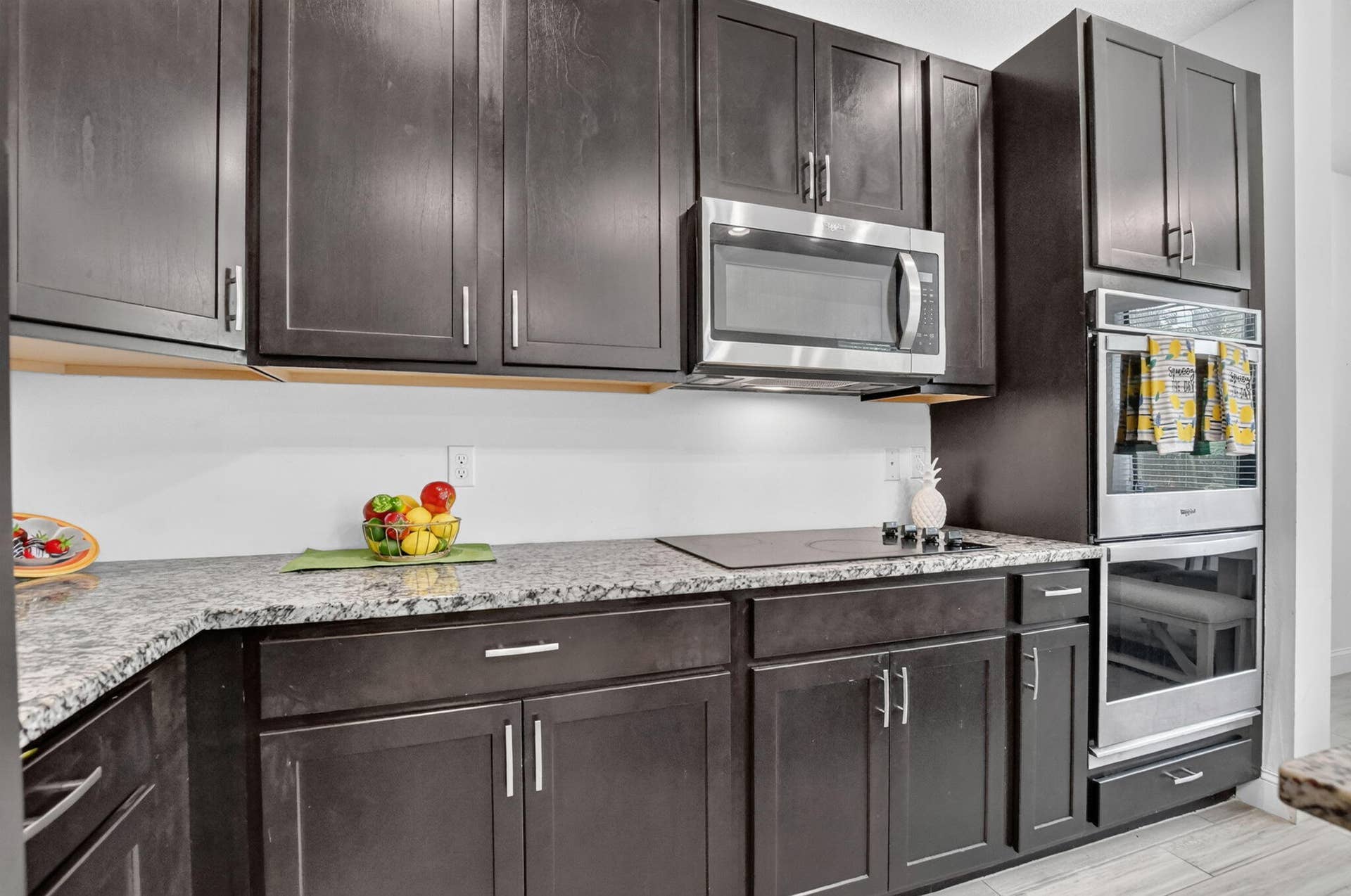 357 NW 36th Avenue, Pompano Beach, FL 33069 Rich coffee colored 42" cabinets with granite counters. S/S appliances and a double oven.