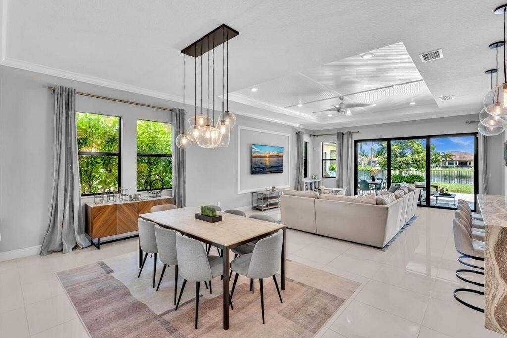 12143 S Baypoint Circle, Parkland, FL 33076 Open-concept living space featuring high ceilings with recessed lighting, large format tile flooring, and sliding glass doors