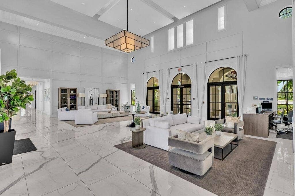 12143 S Baypoint Circle, Parkland, FL 33076 Spacious entry featuring high ceilings, large format tile flooring, and multiple arched glass doors