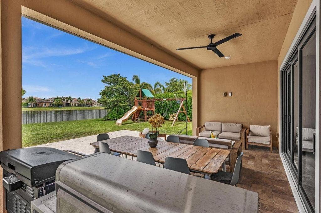 12143 S Baypoint Circle, Parkland, FL 33076 Covered patio featuring a ceiling fan, recessed lighting, and large format tile flooring