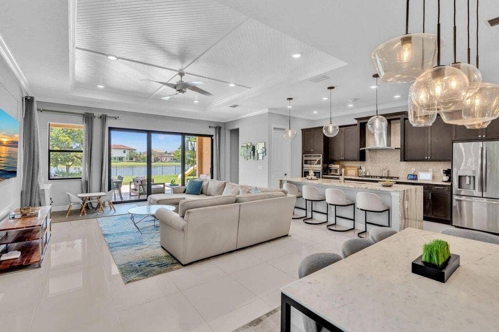 12143 S Baypoint Circle, Parkland, FL 33076 Open-concept living area featuring a coffered ceiling, recessed lighting, and large format floor tiles