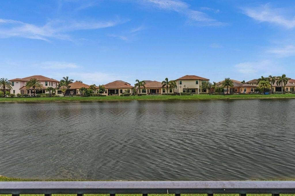 12143 S Baypoint Circle, Parkland, FL 33076 Waterfront properties featuring tile roofs and mature palm trees