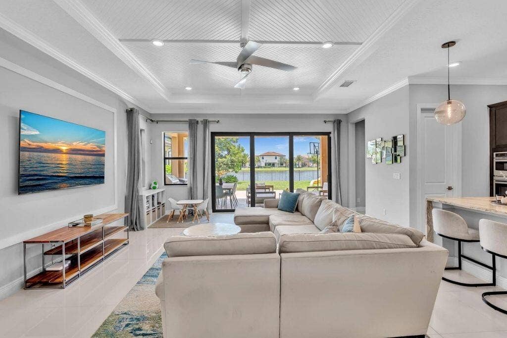 12143 S Baypoint Circle, Parkland, FL 33076 Spacious interior with tile flooring, a coffered ceiling, and a ceiling fan