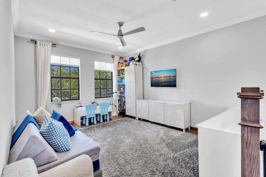 12143 S Baypoint Circle, Parkland, FL 33076 Bright room featuring two large windows with black framing, recessed lighting, and a ceiling fan